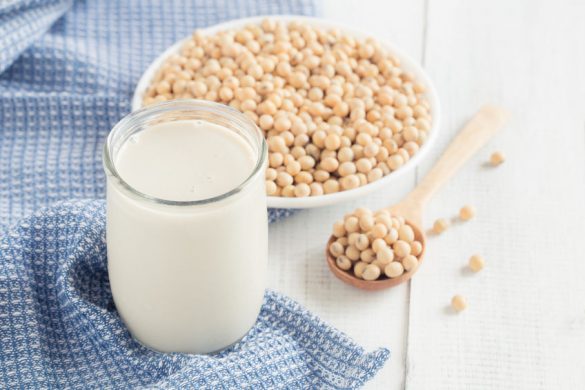 A cup of soy milk and a plate of soybeans